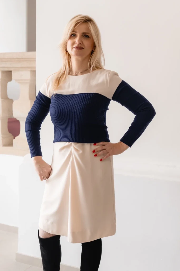 Neutral outfit styled with navy knit arm warmers and waist warmer